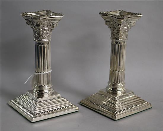 A pair of silver corinthian column candlesticks, Nat Leslie Ltd, Birmingham, 1965, weighted.